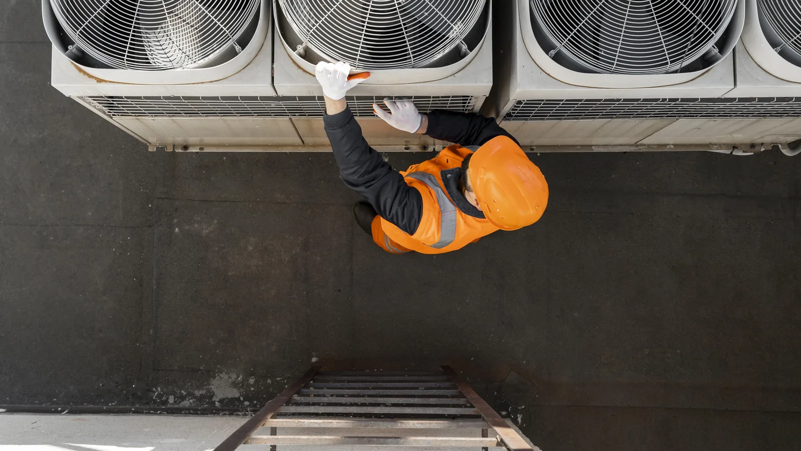 A supervisor checking work on mechanical plant equipment